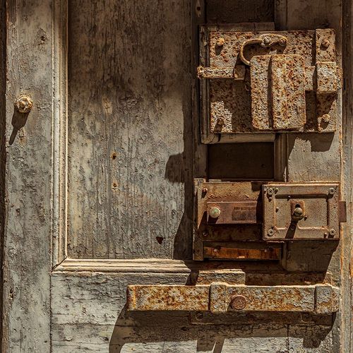 Italy-Apulia-Metropolitan City of Bari-Giovinazzo Old wooden door with massive rusted metal locks